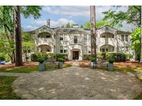 Stunning white-brick exterior with a welcoming stone pathway and elegant landscaping at 65 Peachtree Memorial Nw Dr # 5, Atlanta, GA 30309