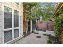 Private brick courtyard featuring mature trees and access to the home at 45 Willow Ne Gln, Atlanta, GA 30342