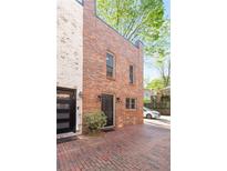Brick townhouse featuring a front door with black hardware and a well-maintained brick driveway at 383 6Th Ne St # 4, Atlanta, GA 30308