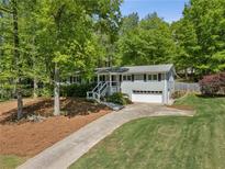 Charming home with lush landscaping, inviting curb appeal, and a well-maintained front yard at 2574 Warwick Dr, Marietta, GA 30062