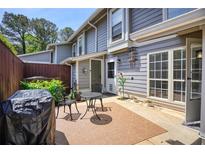 Cozy patio with a grill, seating and decor with a view of the home's exterior at 4992 Meadow Ln, Marietta, GA 30068