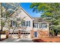Charming two-story home featuring a well-maintained yard and attached two-car garage at 3 S Riversong Ln, Alpharetta, GA 30022