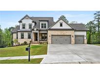 Beautiful two-story home with a brick and shingle facade, three-car garage, and well-manicured lawn at 185 Vandiver Ct, Acworth, GA 30101