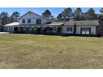 Inviting two-story home features a covered porch and well-maintained lawn at 639 Hall Station Rd, Kingston, GA 30145