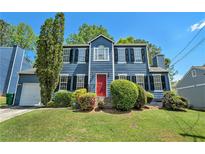 Charming blue two-story home with a bright red front door and well-maintained landscaping at 3455 Kingsbrooke Way, Decatur, GA 30034