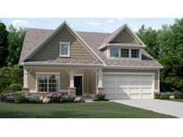 Charming two-story home showcasing a classic design, a two-car garage, and a beautifully landscaped front yard at 1407 Bluffs Ridge Way, Canton, GA 30114