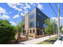 Modern home featuring a mix of brick and metal, plus ample windows for natural light at 1123 W Marietta St, Atlanta, GA 30318