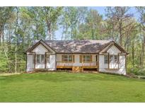 Charming single story home featuring a large, well-manicured front lawn and a welcoming front porch at 639 Ladora Dr, Dallas, GA 30157