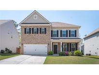 Charming two-story brick and siding home with a well-manicured lawn and an attached two-car garage at 224 Gallant Fox Way, Acworth, GA 30102