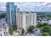 View of the high-rise condo building with balconies and city skyline in the background at 2161 Peachtree Ne Rd # 605, Atlanta, GA 30309