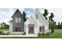 Beautiful two-story home featuring a landscaped front yard and a charming red front door at 6565 Rhett Run, Cumming, GA 30028