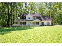 Charming two-story home with a full front porch and a well-manicured lawn at 1061 Retner Dr, Mableton, GA 30126