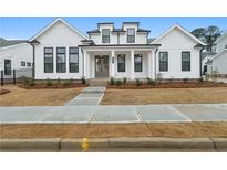 Charming two-story home with modern white siding, black trim, brick walkway, and fresh landscaping at 535 Pearl St, Cumming, GA 30040