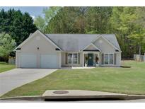 Charming one-story home featuring a well-manicured lawn and a two-car garage at 101 Javay Ct Ct, Villa Rica, GA 30180