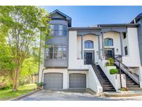 Elegant townhome featuring a two-car garage and grand entrance staircase at 1015 Heatherbrooke Ln, Atlanta, GA 30324