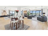 Bright open-plan living area featuring floor-to-ceiling windows, light wood floors, and elegant contemporary furnishings at 3475 Oak Valley Ne Rd # 1720, Atlanta, GA 30326