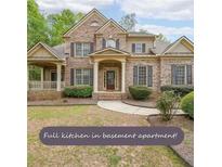 Charming two-story brick home featuring a welcoming entrance, manicured landscaping, and inviting front porch at 2659 Lakefield Sw Pass, Marietta, GA 30064