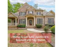 Charming brick two-story home with manicured lawn and mature trees at 2659 Lakefield Sw Pass, Marietta, GA 30064