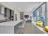 Bright living room with floor to ceiling windows and open layout to the kitchen area at 40 12Th Ne St # 903, Atlanta, GA 30309