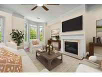 Bright living room features a fireplace, large windows, and a ceiling fan at 2808 Broughton Se Ln, Atlanta, GA 30339