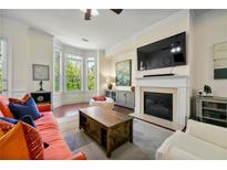 Comfortable living room with a fireplace, bay window and stylish decor at 2808 Broughton Se Ln, Atlanta, GA 30339