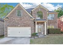 Charming brick home with a two-car garage and well-maintained landscaping at 3861 Sunbridge Dr, Snellville, GA 30039
