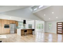Open-concept kitchen with stainless steel appliances and breakfast bar flows into living area at 4544 Savage Ne Dr, Marietta, GA 30066