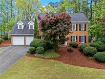 Charming two-story brick home with well-manicured landscaping, a two-car garage, and a classic, inviting facade at 5663 Brookstone Nw Dr, Acworth, GA 30101