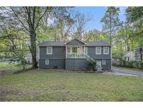 Charming split-level home with gray siding, brick foundation, and a welcoming front porch at 196 Wadley Nw St, Atlanta, GA 30314