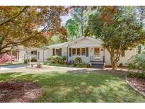 Charming one-story home featuring a well-manicured lawn and a covered carport at 2469 Hunting Valley Dr, Decatur, GA 30033