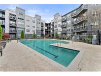 Inviting swimming pool with lounge chairs, surrounded by modern condo building with balconies at 747 Ralph Mcgill Ne Blvd # 223, Atlanta, GA 30312