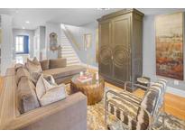 A living room is shown with gray paint and a brown, velvet couch with decorative pillows at 195 Mystic Ct, Atlanta, GA 30342