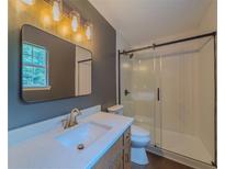 Bathroom featuring a modern vanity, framed mirror, and glass shower doors at 175 Stoneview Cir, Covington, GA 30016