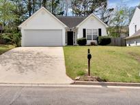 Charming single-story home with a well-manicured lawn, two-car garage, and inviting curb appeal at 2329 Wavetree Nw Ln, Acworth, GA 30101