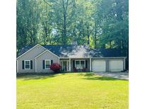 Charming single-story home with a well-manicured lawn, inviting front porch and two-car garage at 3805 Forsythia Way, Douglasville, GA 30135