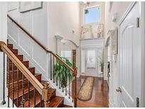 Bright foyer with hardwood floors, staircase, high ceilings, and natural light at 4015 Two Bridge Ct, Buford, GA 30518