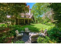 Charming backyard with manicured lawn, mature trees, and inviting outdoor seating area, perfect for relaxation at 2167 W Wesley Nw Rd, Atlanta, GA 30327