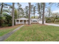 Charming ranch-style home with a welcoming front porch and well-maintained lawn, creating inviting curb appeal at 2000 Hill Rd, Marietta, GA 30062
