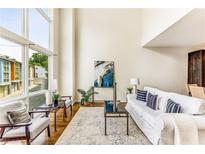 Bright living room with floor-to-ceiling windows, hardwood floors and neutral decor at 1390 Stirling Nw Cir, Atlanta, GA 30318