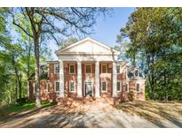 Stately brick home featuring a grand facade with white columns and a classic design at 1961 River Forest Rd, Atlanta, GA 30327