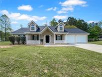 Charming one-story home with dormer windows, a two-car garage, a covered porch, and a spacious front yard at 41 Olde Town Way, Rockmart, GA 30153