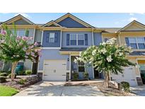 Charming townhome with well-maintained landscaping, a two-car garage, and welcoming curb appeal at 265 Valley Xing, Canton, GA 30114