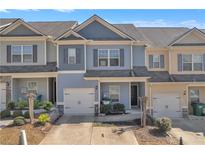 Charming two-story townhome with well-maintained landscaping and attached one car garage at 265 Valley Xing, Canton, GA 30114