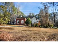 Well-manicured front yard of a charming home with a combination of brick and stucco exterior at 175 Oak Manor, Fayetteville, GA 30214