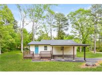 Charming single story home with a front porch and convenient covered parking area at 5170 2Nd St, Morrow, GA 30260