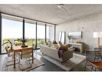 Bright living room with large windows, city views, modern furnishings, and stylish decor at 480 John Wesley Dobbs Ne Ave # 716, Atlanta, GA 30312
