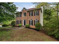 Charming two-story brick home with black shutters and manicured landscaping at 507 Matthew Dr, Canton, GA 30115