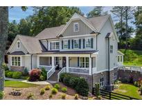 Beautiful two-story home with a covered porch, shutters, and a well-maintained front yard at 110 White Oak Trl, Cumming, GA 30028