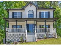 Charming two-story home featuring a welcoming front porch and manicured lawn at 1331 Windage Sw Ct, Marietta, GA 30008