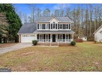 Charming two-story home with a welcoming front porch and attached two-car garage at 128 Brookhaven Ln, Mcdonough, GA 30253